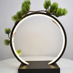 circle lamp illuminating a small potted plant